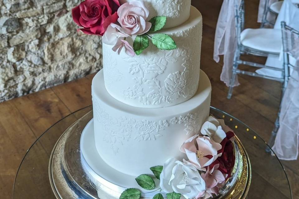 Lace and sugar flowers on cake