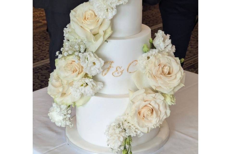 Flowers swirl on white cake