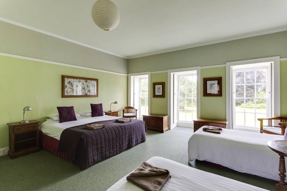 Bedroom overlooking the front lawn with two twin beds added to the room