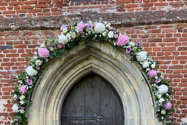 Church archway with milk churn
