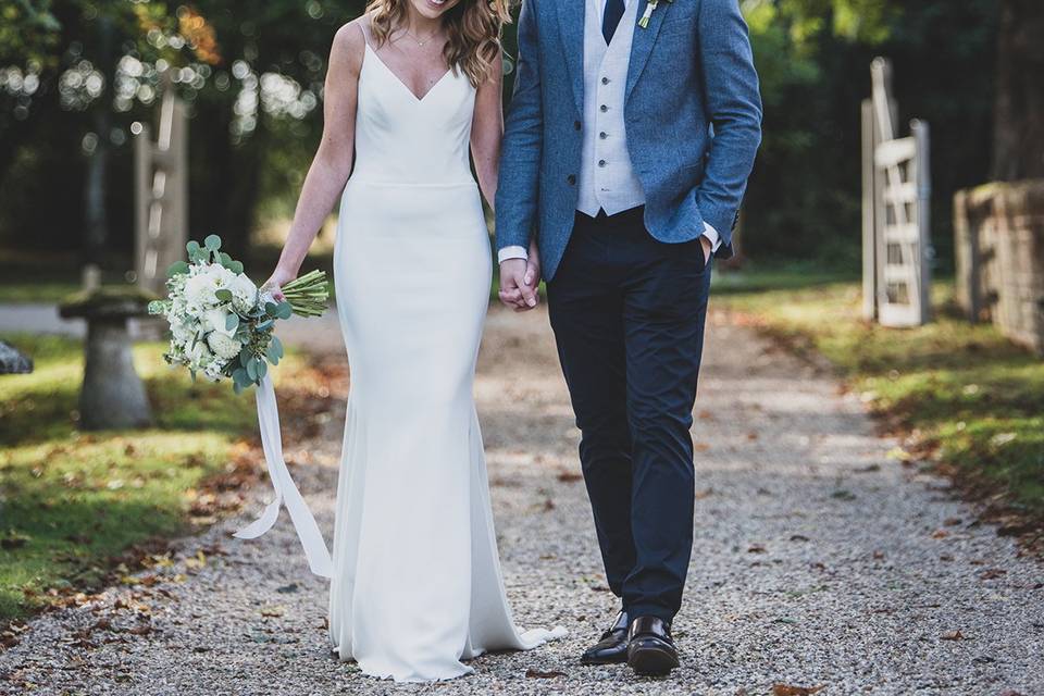 Newlyweds walk down a path