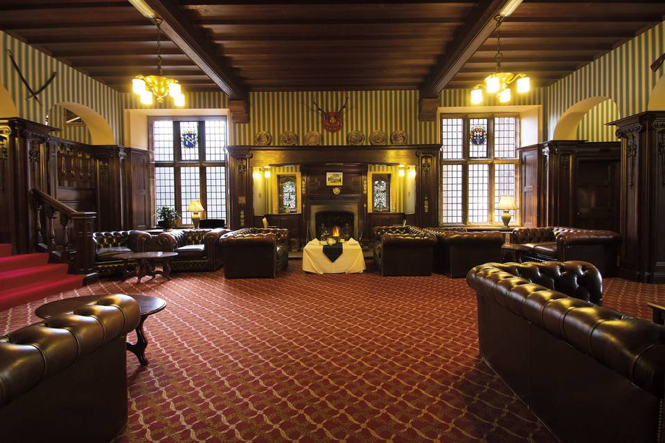 The oak-panelled Lounge and fireplace at Friars Carse