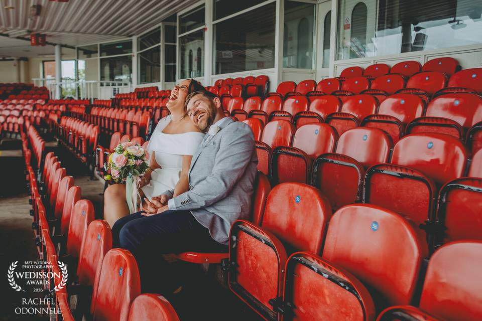 Bride + groom laugh in stands