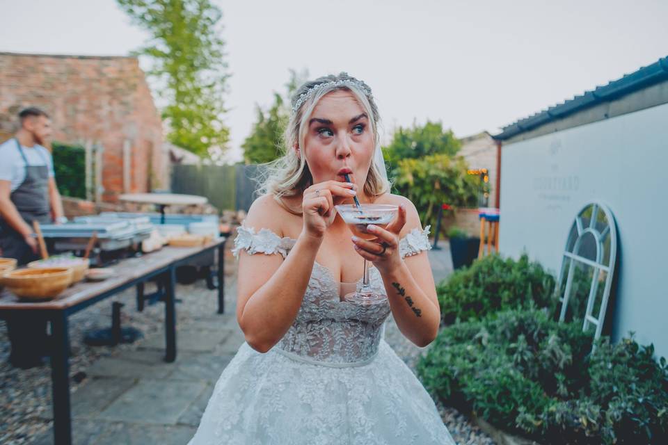 Bride sips cocktail