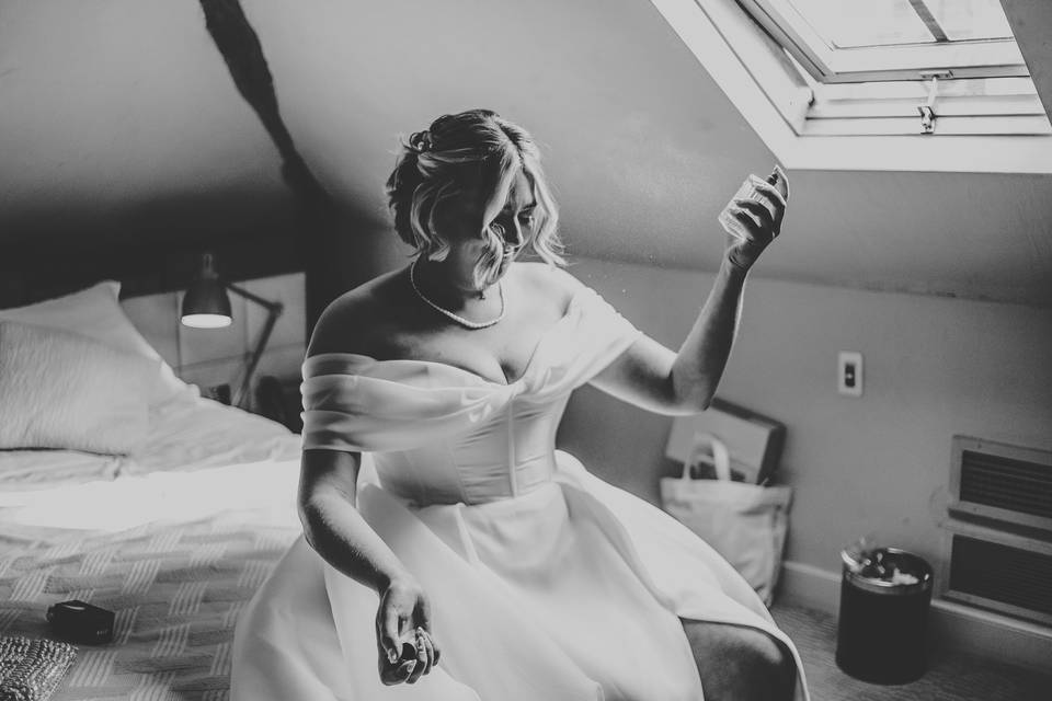 Bride spraying perfume