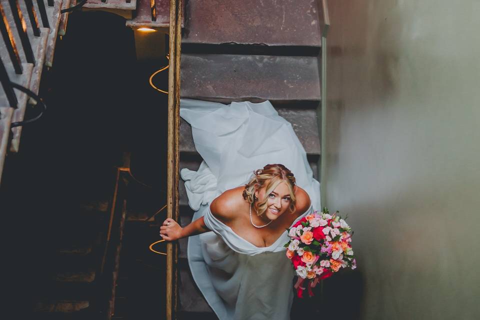 Bride gliding down the stairs