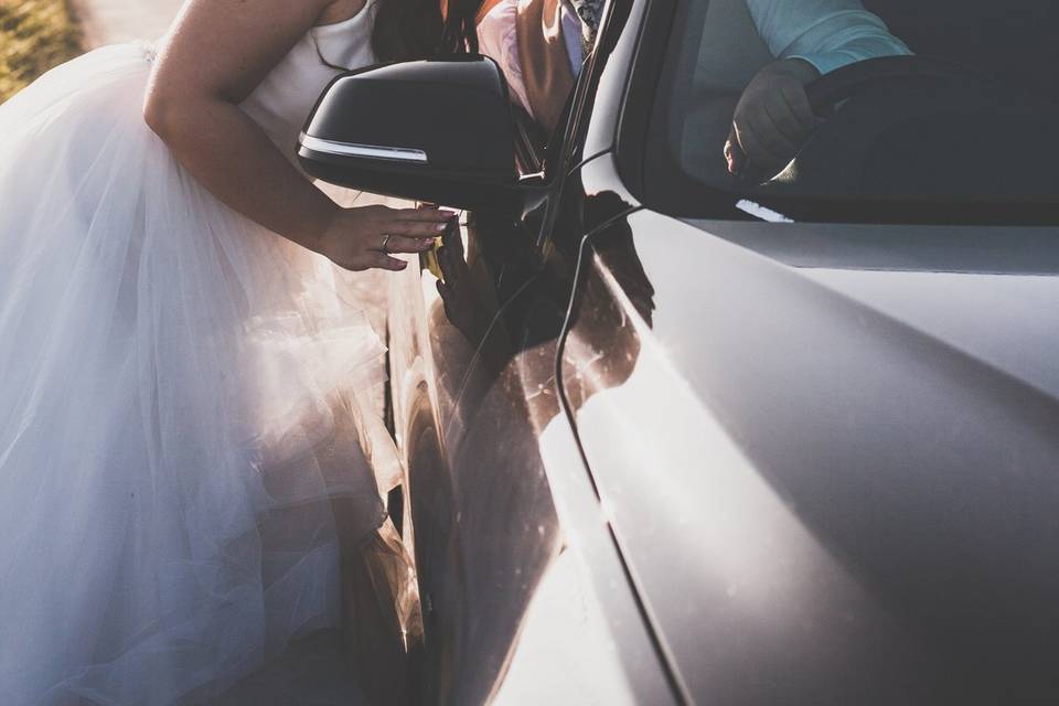Bride and groom with getaway car
