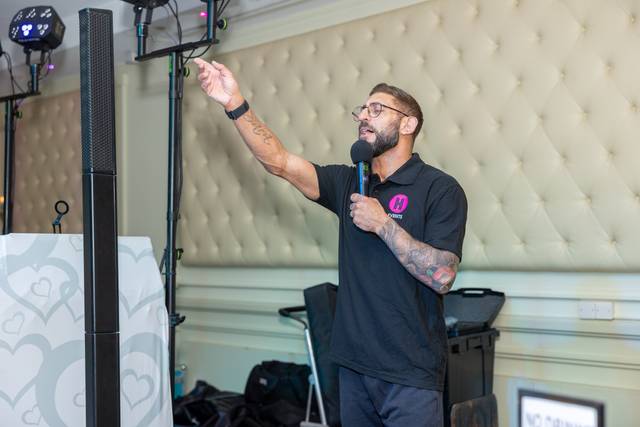 dj speaking into microphone pointing up