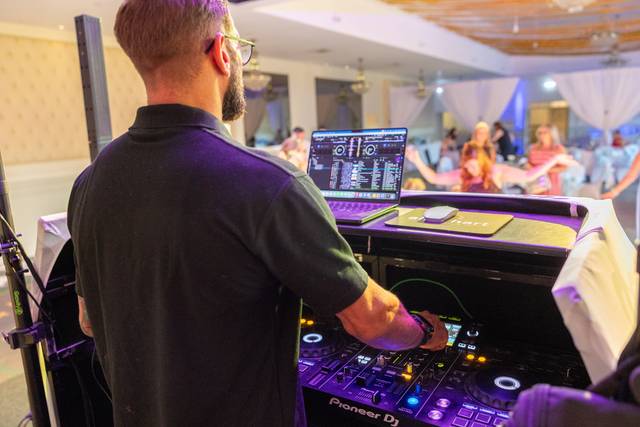 close up of dj using pioneer mixer console at night