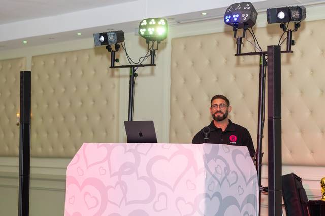 dj booth with pink pattern and lighting rig