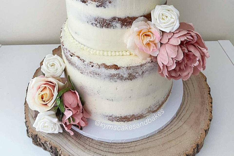 Semi-naked wedding cake with bunting