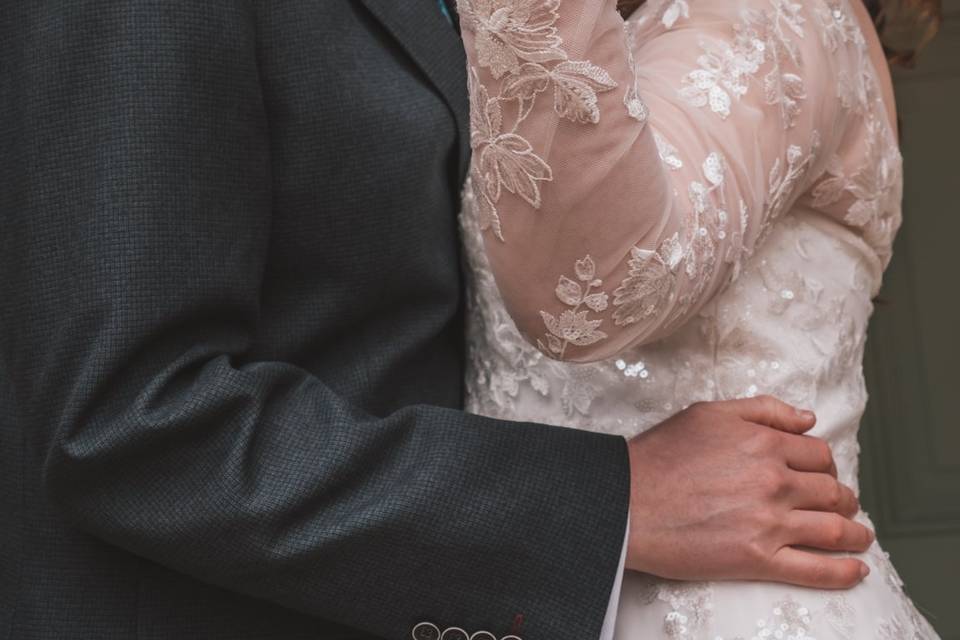 Couple kissing behind hand