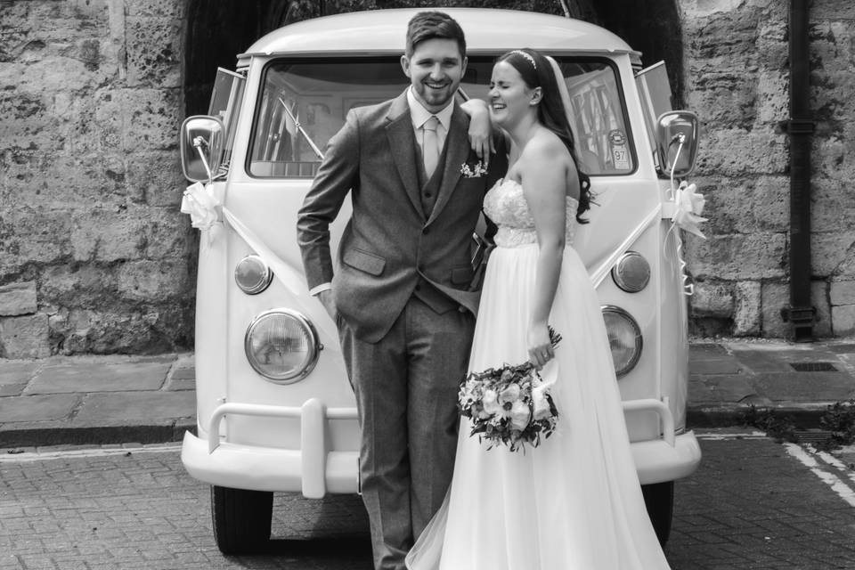 Couple in front of wedding car