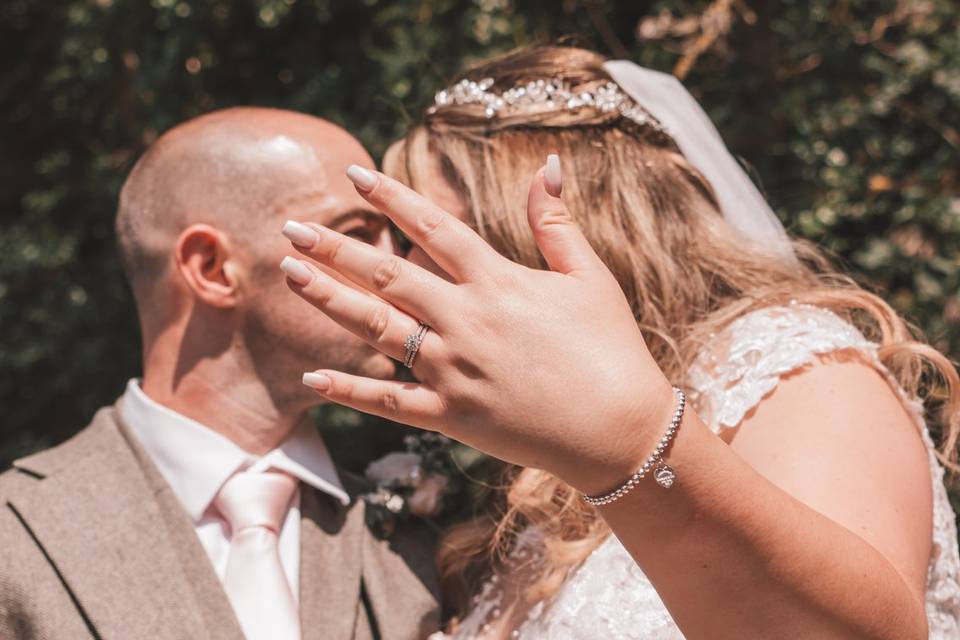 Couple kissing behind hand