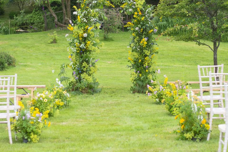 Floral archway & meadow aisle