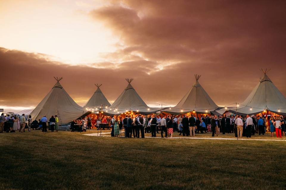 Six tipis at sunset