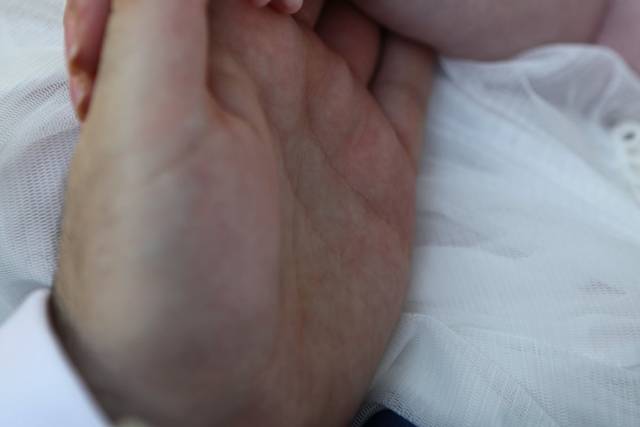 Bride and groom with their baby