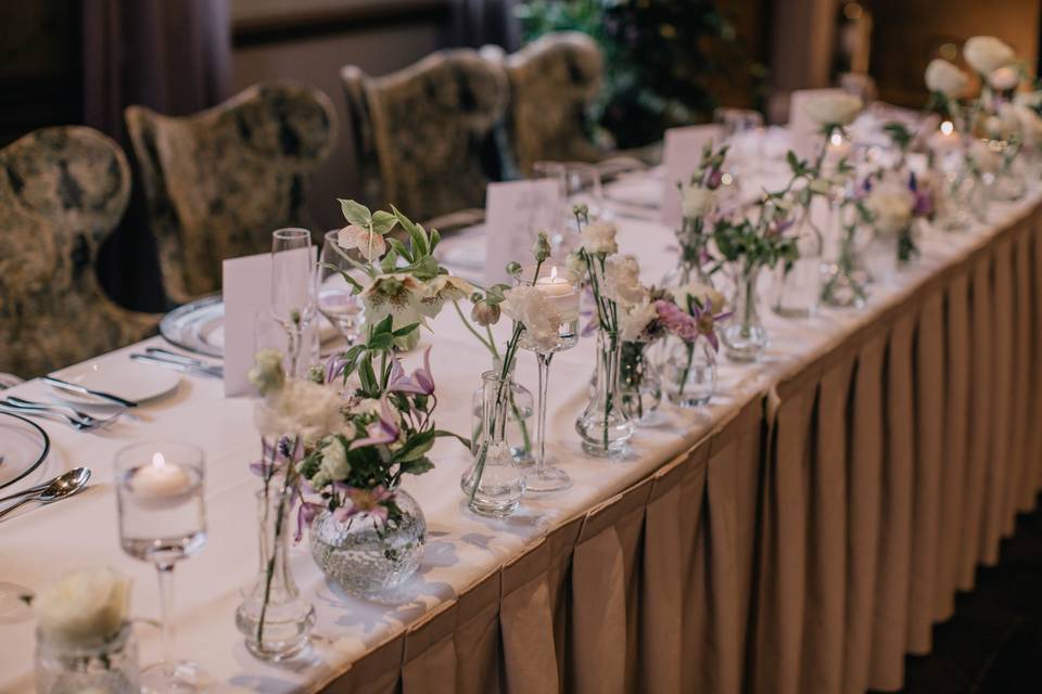 Bud vases across a top table