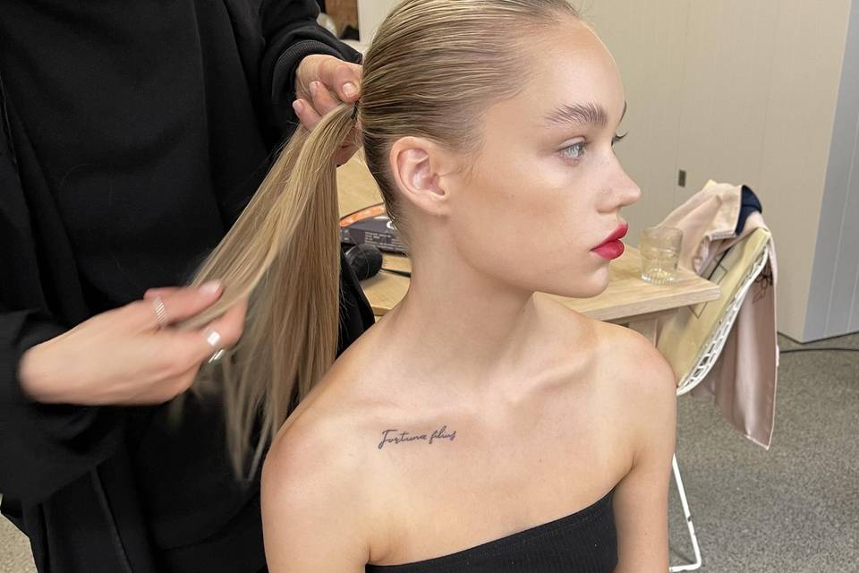 Sleek pony tail and red lip