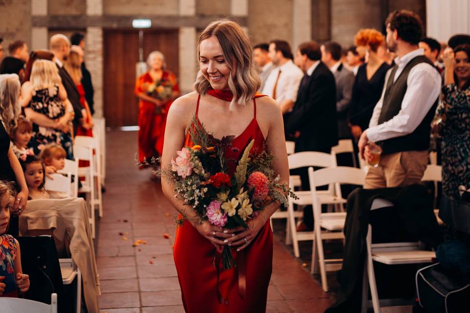 Bridesmaid walking down the is