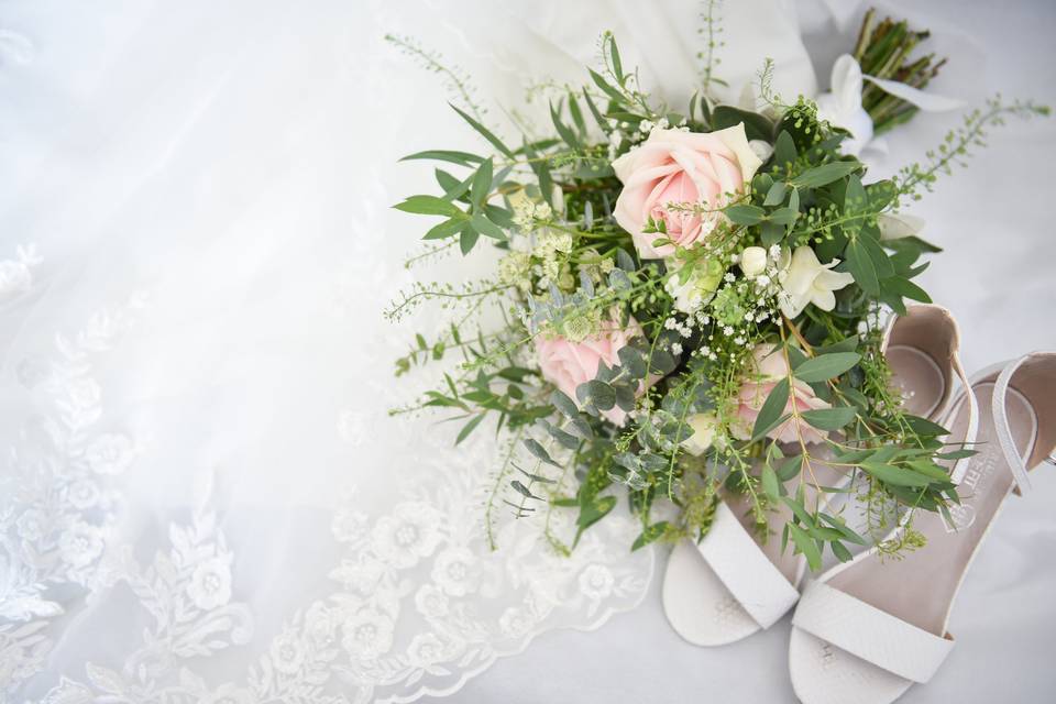 Bridal shoes, dress, and flowers