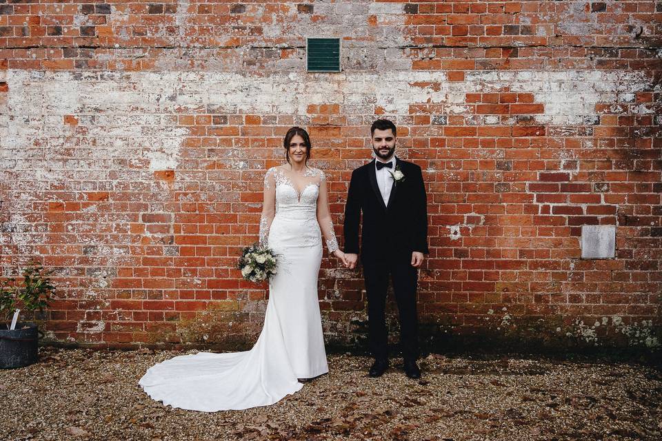 Couple in front of brick build