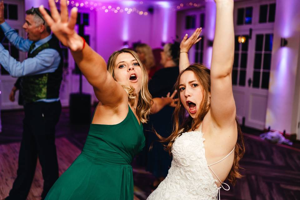 Bride and sister dancing