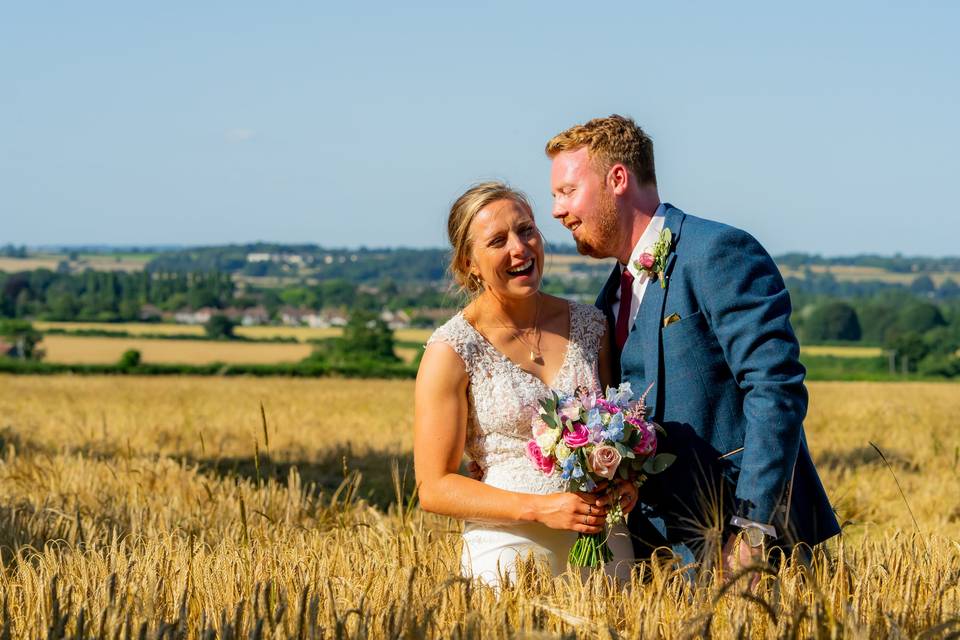 Bride and groom in barley field