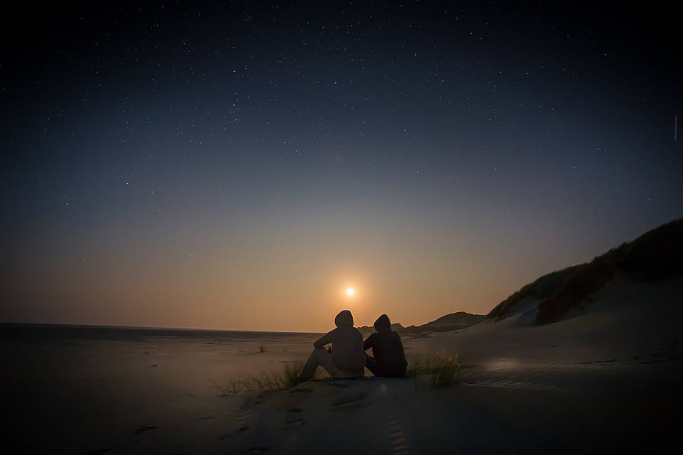 Couple watching the sunset tog