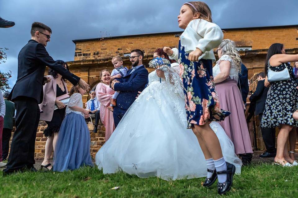 Little girl jumping at wedding