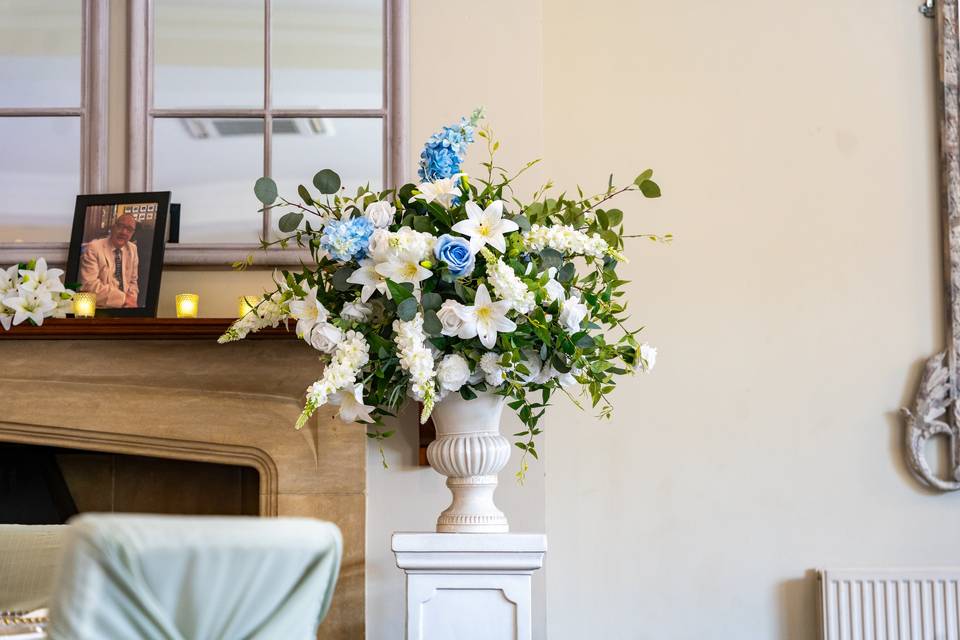 Floral arrangement in front of fireplace
