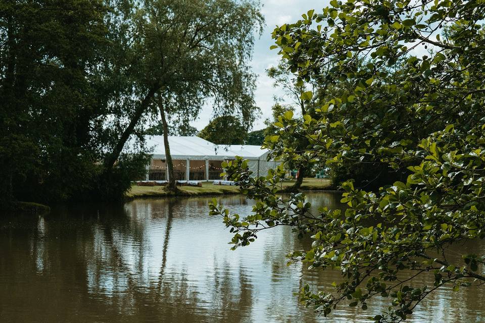 Marquee next to a lake