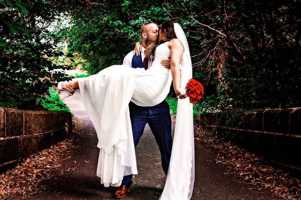 Groom carrying Bride