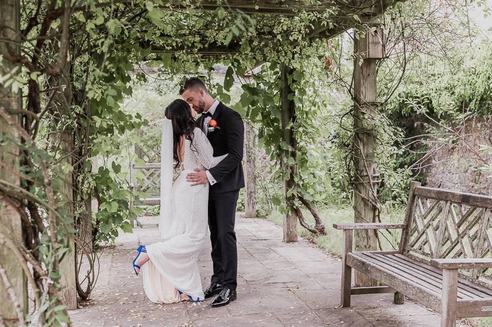 Bride and groom garden kiss