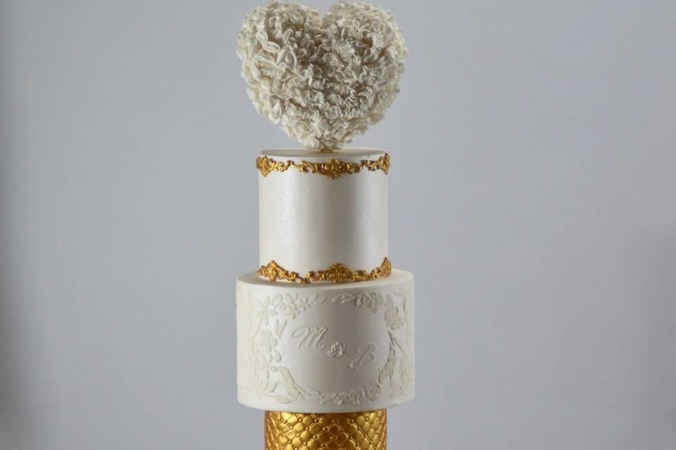 Four-tier gold and white cake