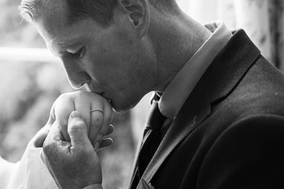 Kissing his brides hand