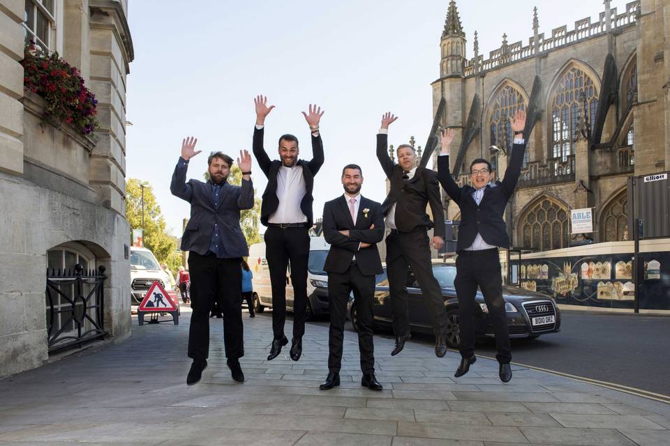 Groom & jumping ushers