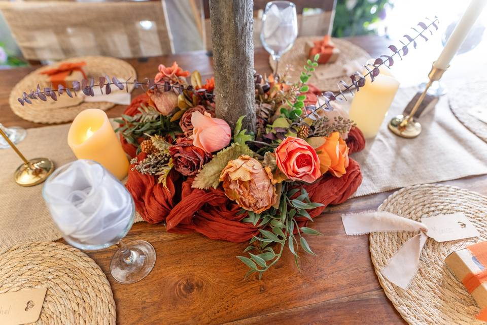Close-up of autumnal floral centerpiece on wood
