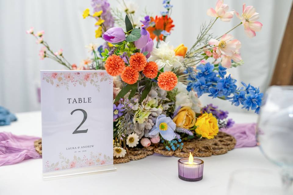 Colorful wildflower centerpiece with table number
