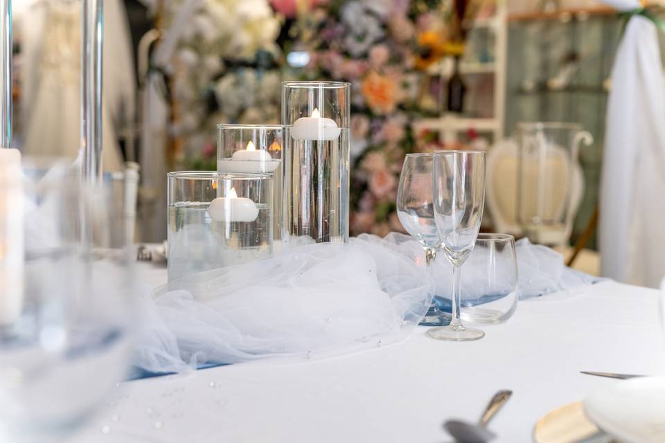 Grouping of candles and glassware on a table