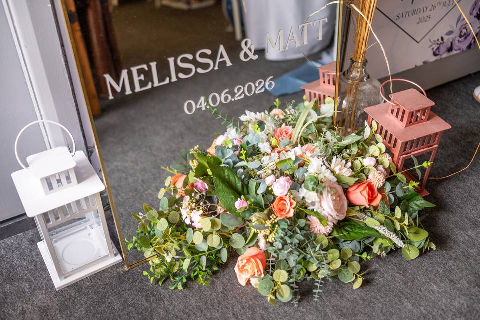 Personalized sign on floor surrounded by flowers