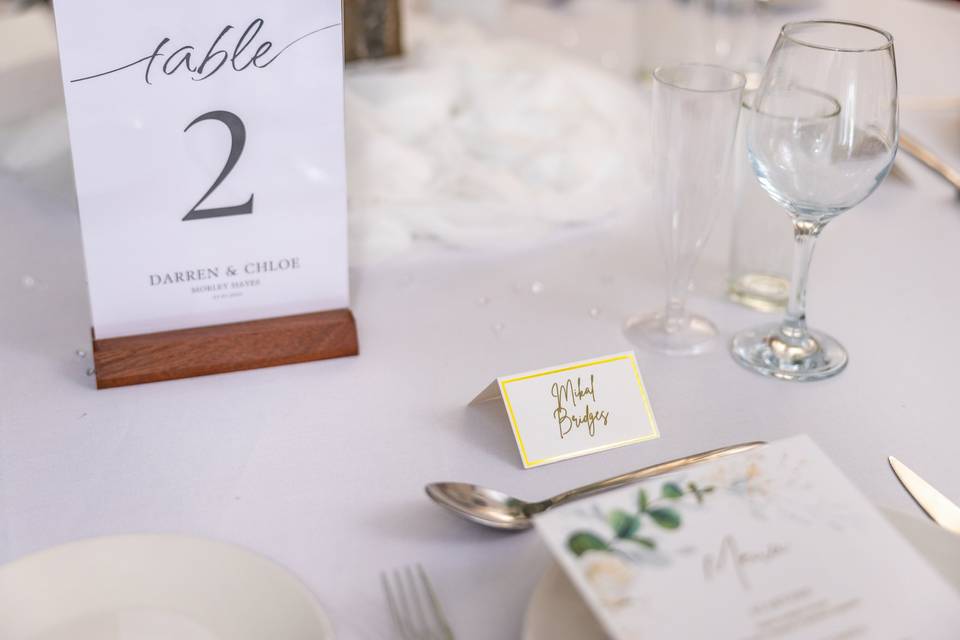 Table number sign next to a floral menu card