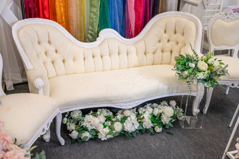 White ornate vintage sofa with floral base
