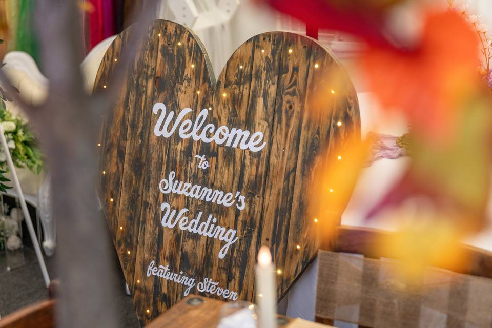Wooden heart-shaped wedding welcome sign