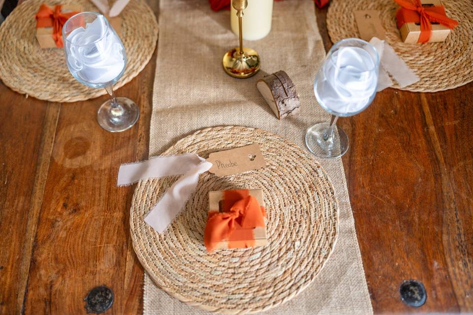 Woven placemat with orange napkin on wood