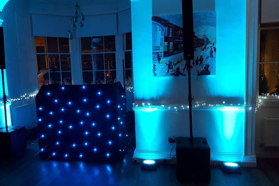 White DJ booth with uplighting