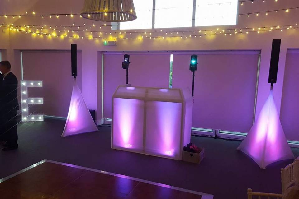 White DJ booth with uplighting