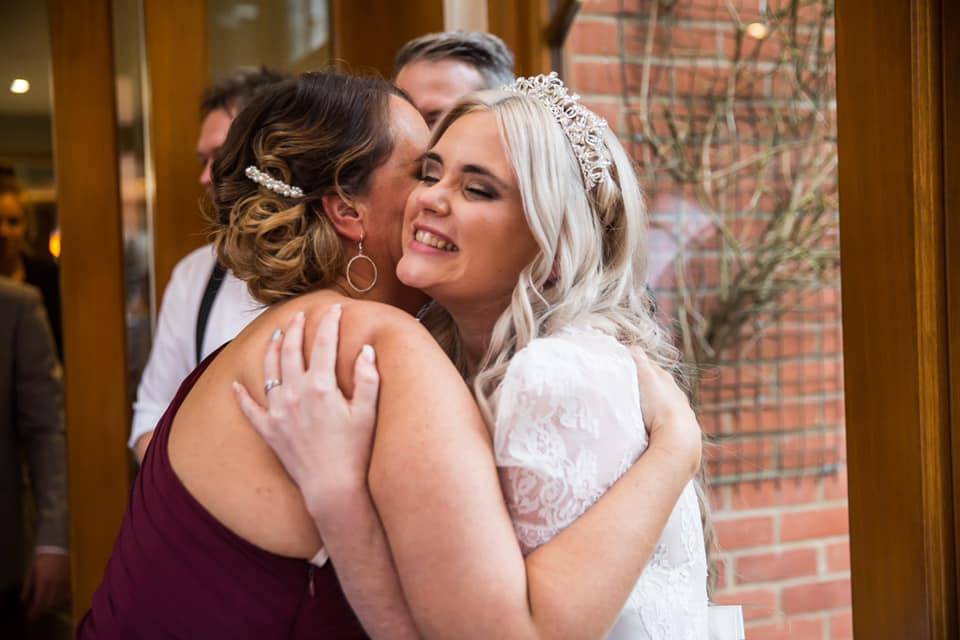 Hugging the bride