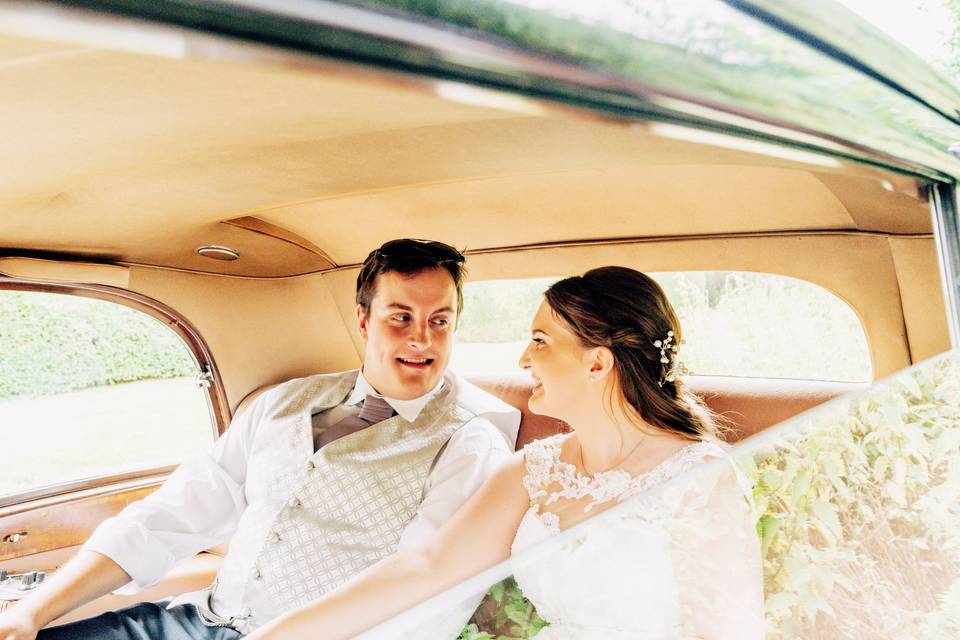 Newlyweds in a wedding car