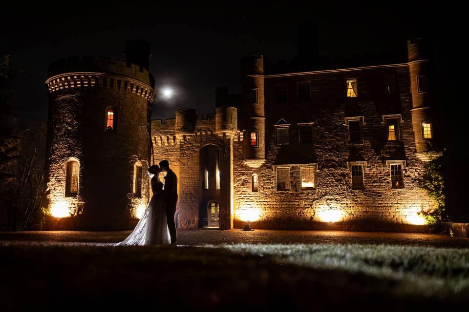 Castle and couple at night